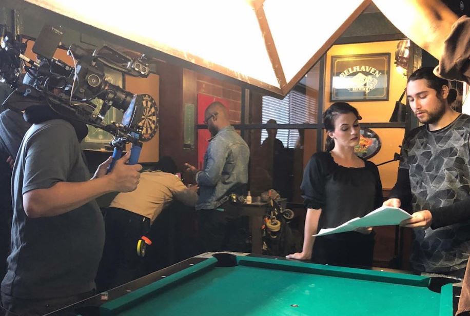 A professional film crew shoots a scene in a bar with a pool table, suitable for Corporate Video Production Company Spring in Branch West
