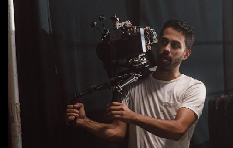 A male videographer holding a professional camera on his shoulder, ideal for Corporate Video Production Agency in Houston