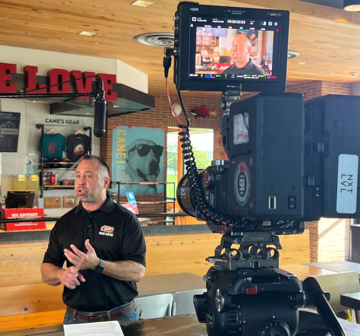 A filmmaker captures a man speaking in a business setting, suitable for Commercial Video Production Company in Spring Branch West