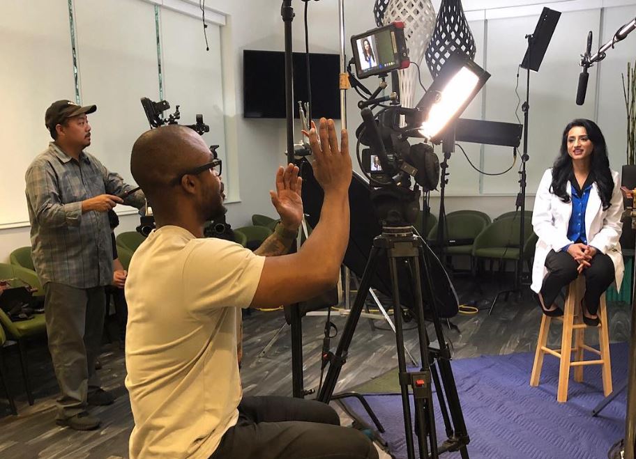 A video production team films a dentist sitting on a stool for Dental Video Production in Spring Branch West