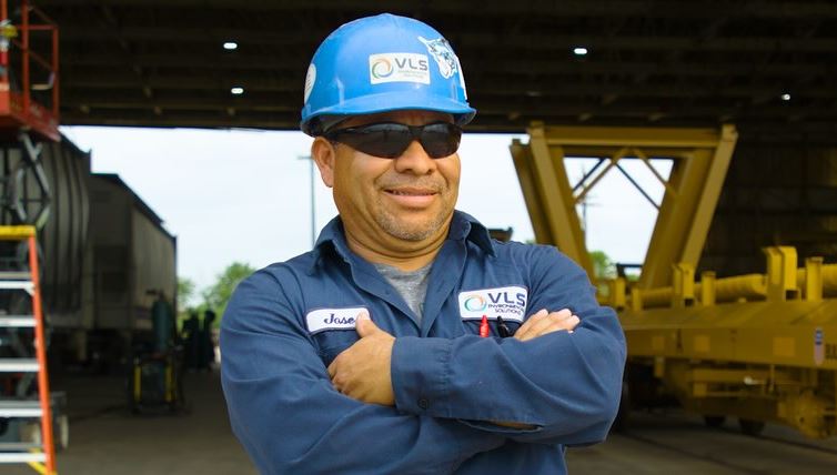 A man speaks into a microphone while being filmed, representing the production of Workplace Safety Training Videos in Spring Branch West