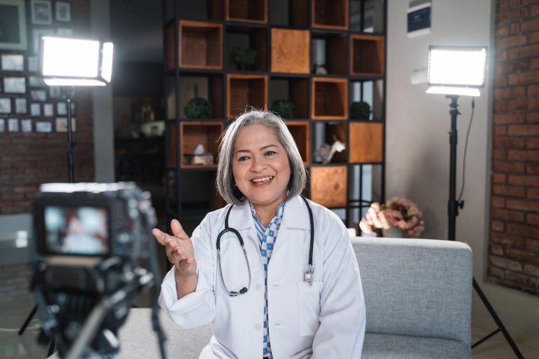 Dentist explainer video production in Houston featuring a smiling dentist recording a session with professional lighting.