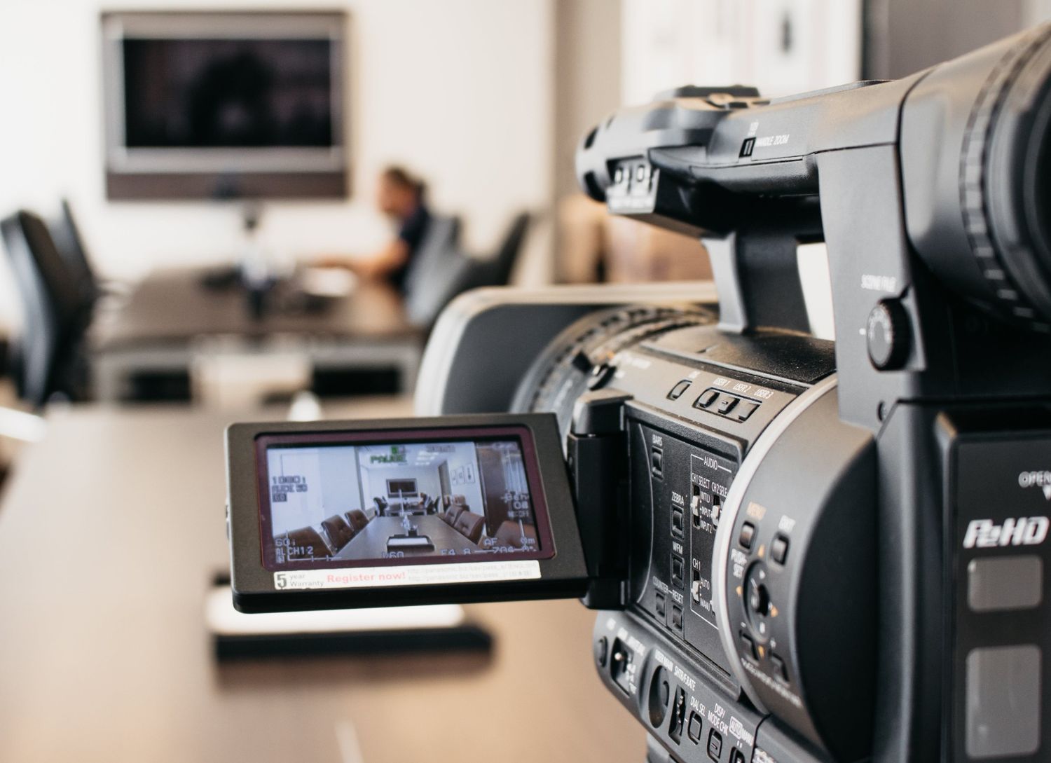 Camera recording a corporate meeting for a corporate video production agency in Houston's professional boardroom.