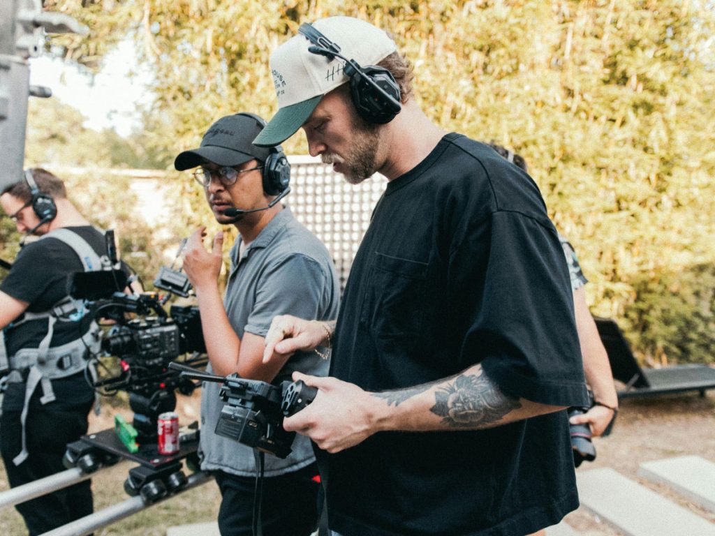 Videographers with headphones filming Dental Procedure Explainer Videos in Houston, collaborating on set with equipment.