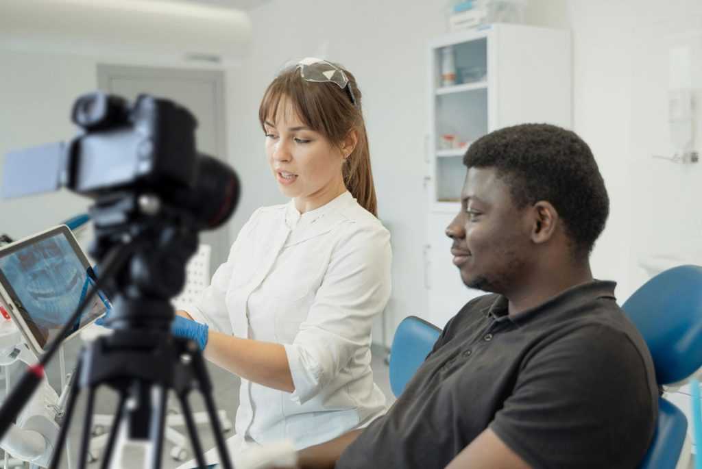 Dentist recording patient consultation for engaging Dental Procedure Explainer Videos marketing strategy in Houston.