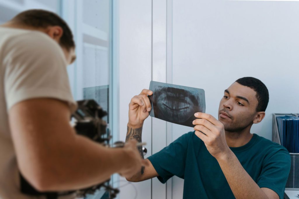 Dentist reviews patient X-ray to create high-quality, informative Dental Procedure Explainer Videos for local promotion.