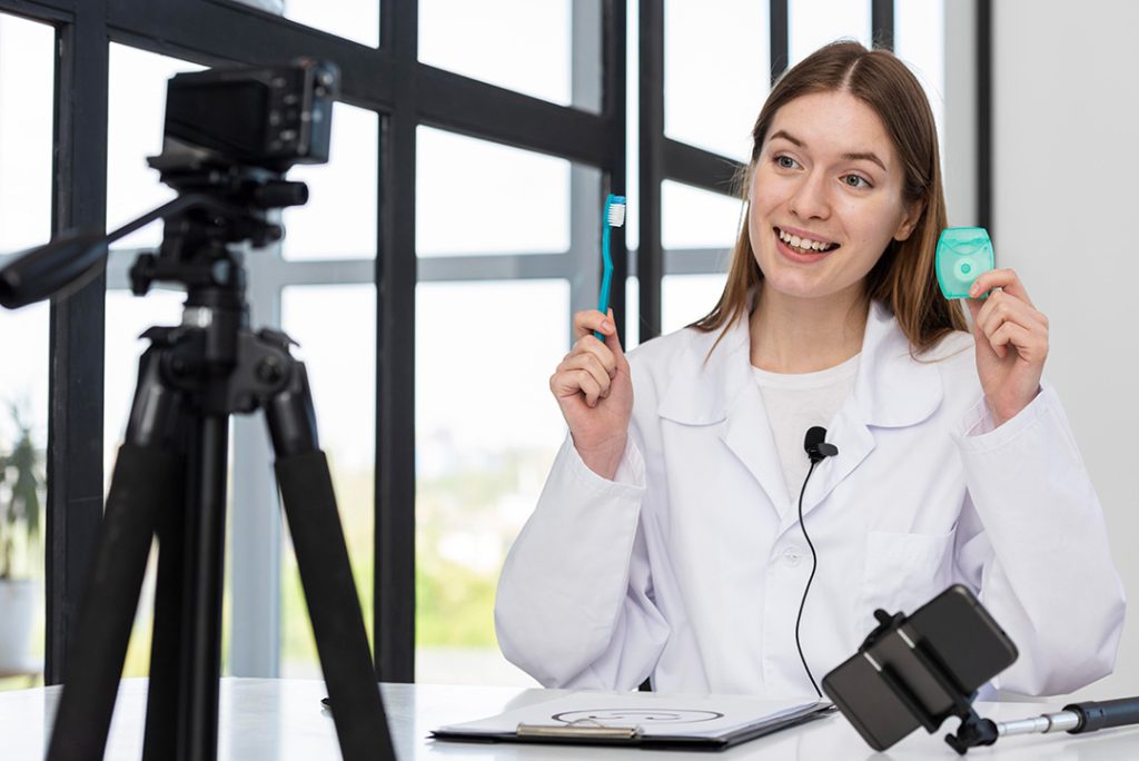 Houston dentist filming dental practice marketing video demonstrating toothbrush and floss for oral hygiene tips