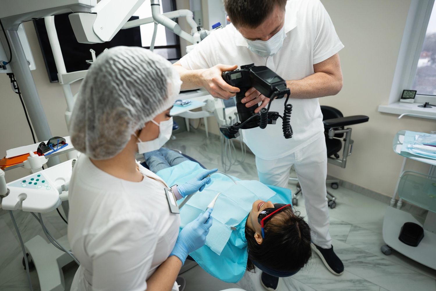 Dental professional taking a dental office tour video in Houston with a patient in chair