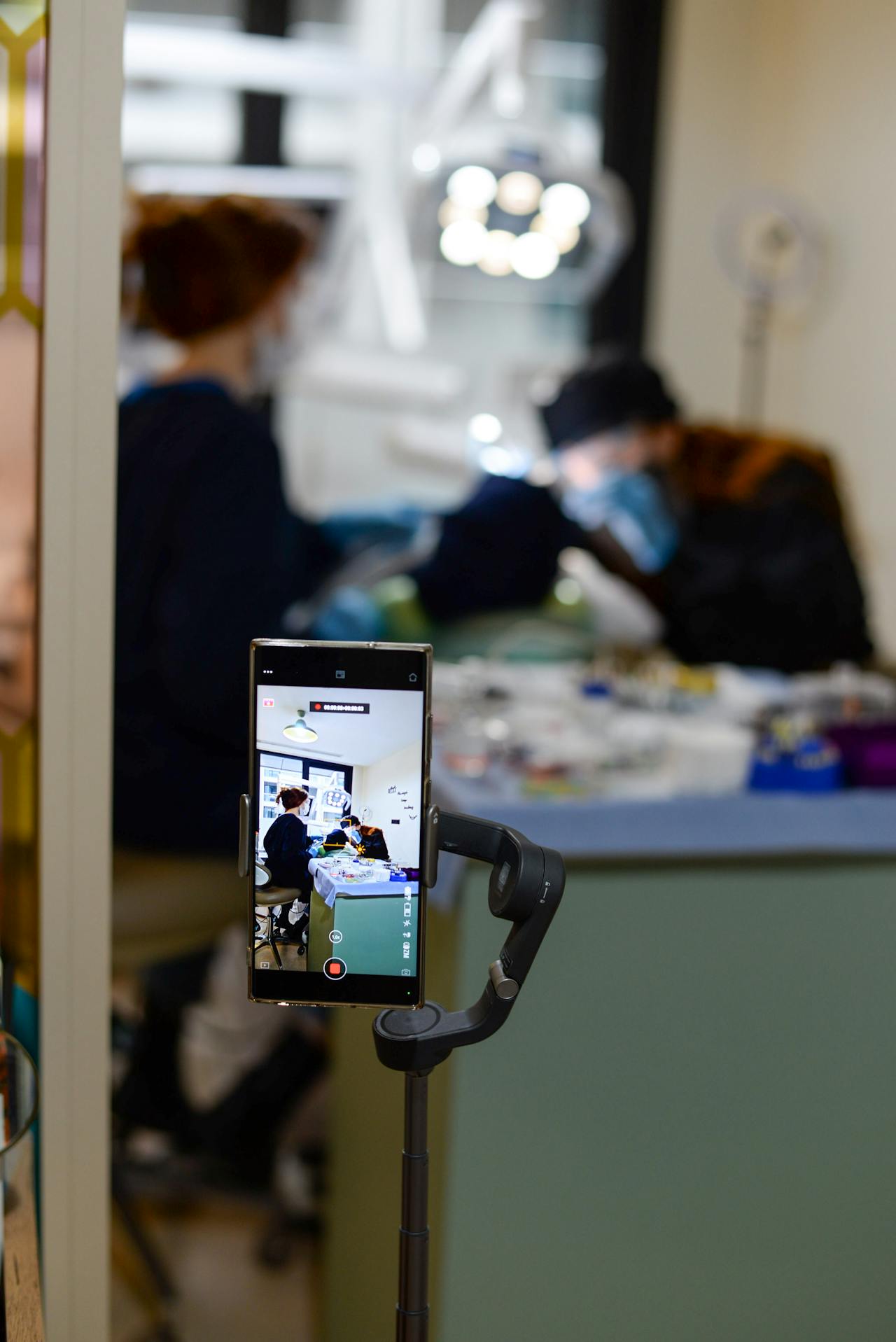 A smartphone on a stabilizer filming a procedure in a clinic for dental social media videos in Houston.