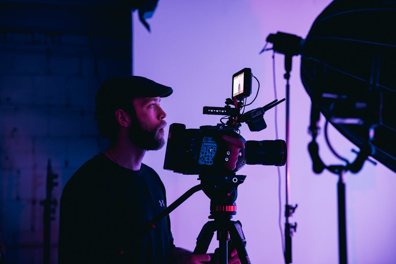 A professional cinematographer operating a cinema camera in a studio, representing expert film production in Houston.