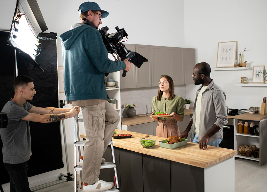 Expert videographer framing a talent shot during an infomercial video production houston in a modern studio space.