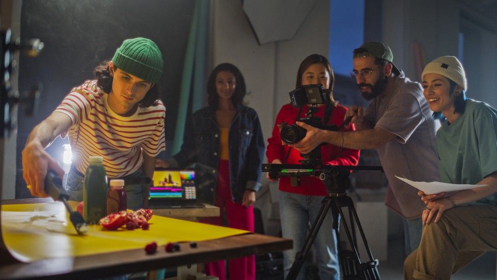 Creative team from a videography company Houston working in a professional studio capturing food-based commercial content.
