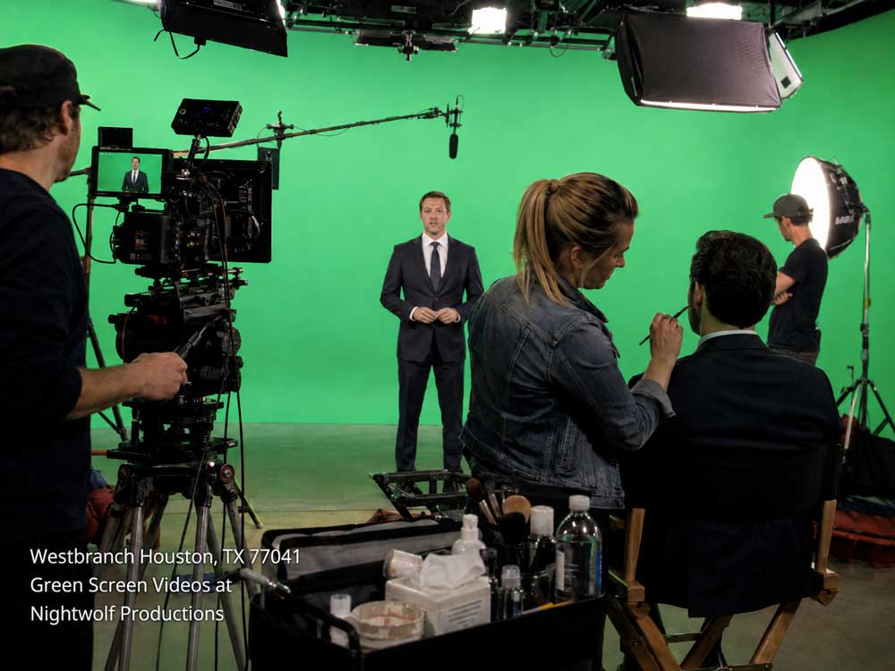 Behind the scenes setup of high-quality green screen videos with a professional crew, makeup artist, and actor.