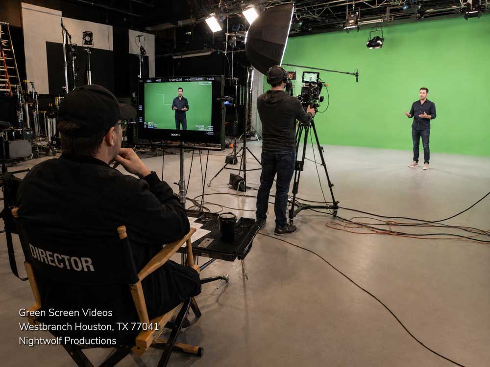 Director monitoring the filming of green screen videos inside a professional video production studio in Houston.