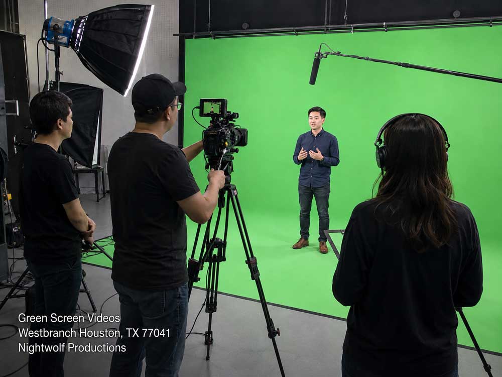 Professional film crew using high-end cameras to shoot green screen videos with a spokesperson in a studio.
